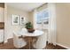 Cozy breakfast nook with a round table, surrounded by ample natural light from a large window at 392 Summer Squall Rd, Davenport, FL 33837