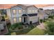 Charming two-story home with a well-manicured lawn and brick-paved driveway, showcasing its inviting curb appeal at 392 Summer Squall Rd, Davenport, FL 33837