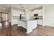 Modern kitchen featuring white cabinets, granite countertops, stainless steel appliances, and a stylish center island at 392 Summer Squall Rd, Davenport, FL 33837