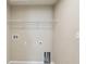 Laundry room boasts convenient hookups, shelving, and modern wall paint at 392 Summer Squall Rd, Davenport, FL 33837