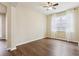 Bright living room with dark wood floors, large window, and natural light at 392 Summer Squall Rd, Davenport, FL 33837