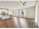 Spacious living area featuring wood flooring, a ceiling fan, and natural light, providing a bright and open atmosphere at 392 Summer Squall Rd, Davenport, FL 33837