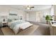 Spacious main bedroom featuring a ceiling fan and ensuite bathroom at 392 Summer Squall Rd, Davenport, FL 33837