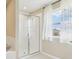 Shower featuring glass doors and tile surround at 392 Summer Squall Rd, Davenport, FL 33837