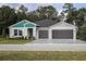 Charming single-story home featuring a two-car garage, well-manicured lawn, and modern architectural details at 6230 Sw 95Th Pl, Ocala, FL 34476