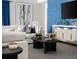 Comfortable living room with modern furniture, stylish decor, blue accent wall, and lots of natural light at 6230 Sw 95Th Pl, Ocala, FL 34476