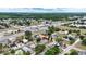 Wide aerial view showcasing the home location relative to nearby businesses and roadways at 1002 Ne 1St St, Mulberry, FL 33860