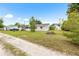 View of backyard with home exterior featuring neutral color and lush green yard at 1002 Ne 1St St, Mulberry, FL 33860