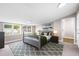 Comfortable bedroom with large windows, a gray bed frame, and stylish decor at 1002 Ne 1St St, Mulberry, FL 33860