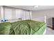 Bedroom featuring green bedding, gray walls, carpeted floors, and white trim at 1002 Ne 1St St, Mulberry, FL 33860