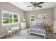 Bright bedroom with a white bed, dresser, and play area at 1002 Ne 1St St, Mulberry, FL 33860