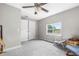 Bedroom with plush carpet, ample natural light from a window, and convenient closet storage at 1002 Ne 1St St, Mulberry, FL 33860