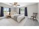 Bedroom with large windows, cozy decor, and a ceiling fan at 1002 Ne 1St St, Mulberry, FL 33860