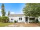 Charming single-story home featuring a neatly landscaped yard and a welcoming front entrance at 1002 Ne 1St St, Mulberry, FL 33860