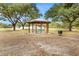 A community gazebo with picnic tables provides a shaded area for gatherings and relaxation at 1002 Ne 1St St, Mulberry, FL 33860