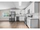 Modern kitchen with stainless steel appliances, white cabinets, and granite countertops at 1002 Ne 1St St, Mulberry, FL 33860