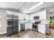 Modern kitchen with stainless steel appliances, white cabinets, and granite countertops at 1002 Ne 1St St, Mulberry, FL 33860