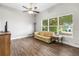 Bright living room featuring hard surface floors, ceiling fan, and large windows at 1002 Ne 1St St, Mulberry, FL 33860