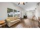 Spacious living room with large windows, wood-look floors, and abundant natural light at 1002 Ne 1St St, Mulberry, FL 33860