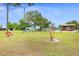 The neighborhood playground offers green space with swings and a unique, red spinning attraction at 1002 Ne 1St St, Mulberry, FL 33860
