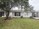 Backyard and exterior view of house showing grass, air conditioner, and enclosed patio at 13140 Summerton Dr, Orlando, FL 32824