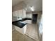 Bright kitchen featuring white cabinets, dark countertops, and tile flooring at 5532 Stull Ave, Orlando, FL 32810