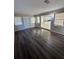 Open-concept living room with hardwood floors and access to the kitchen at 5532 Stull Ave, Orlando, FL 32810