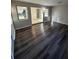 Living room features hardwood floors, natural light, and a glimpse into the kitchen at 5532 Stull Ave, Orlando, FL 32810