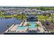 Aerial view of community pool and playground next to a lake and modern homes at 617 Terrapin Dr, Debary, FL 32713