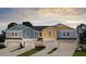 New townhomes show a colorful exterior, driveway, and manicured landscaping at 3775 King Hill Dr, Haines City, FL 33844