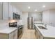 Spacious kitchen featuring stainless steel appliances, gray cabinets, and a center island at 3775 King Hill Dr, Haines City, FL 33844