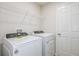 Functional laundry room with modern washer and dryer, plus convenient overhead shelving at 3775 King Hill Dr, Haines City, FL 33844
