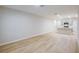 Bright and airy living room features light wood flooring and a view into the kitchen at 3775 King Hill Dr, Haines City, FL 33844