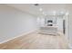 Open-concept living room with light wood flooring, recessed lighting, and a view into the kitchen at 3775 King Hill Dr, Haines City, FL 33844