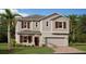 Charming two-story home with neutral siding, red shutters, and a well-manicured lawn at 4654 Ackee Rd, Kissimmee, FL 34758