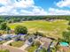 Aerial view of a neighborhood with baseball fields, a park and single-Gathering houses at 728 Waterbridge Dr, Winter Haven, FL 33880
