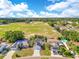 Aerial view of a neighborhood with baseball fields, a park and single-Gathering houses at 728 Waterbridge Dr, Winter Haven, FL 33880