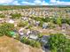 This aerial highlights a residential community featuring well-maintained homes, lush greenery, and inviting backyard swimming pools at 728 Waterbridge Dr, Winter Haven, FL 33880