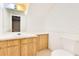 Simple bathroom with a wood vanity, white counter, toilet and mirror at 728 Waterbridge Dr, Winter Haven, FL 33880