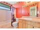 Red themed bathroom with a shower and tub combo and wood cabinet at 728 Waterbridge Dr, Winter Haven, FL 33880