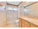Bathroom featuring tiled walk-in shower, and wood vanity with granite countertop at 728 Waterbridge Dr, Winter Haven, FL 33880