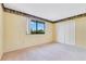 Bright bedroom with neutral carpet, large window, and closet at 728 Waterbridge Dr, Winter Haven, FL 33880