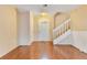 Inviting foyer with a staircase, featuring sleek hardwood floors and a well-lit entrance with a decorative door at 728 Waterbridge Dr, Winter Haven, FL 33880