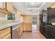 Kitchen featuring stainless steel dishwasher, neutral countertops and access to the outdoor patio at 728 Waterbridge Dr, Winter Haven, FL 33880