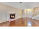 Cozy living room with a fireplace and hardwood floors, illuminated by natural light from the front door at 728 Waterbridge Dr, Winter Haven, FL 33880