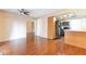 Open-concept layout featuring wood floors, and views of the kitchen and entry way at 728 Waterbridge Dr, Winter Haven, FL 33880