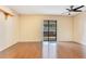 Bright living room featuring a ceiling fan and sliding door that leads to the lanai at 728 Waterbridge Dr, Winter Haven, FL 33880