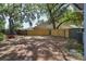 Large backyard features mature trees and a wooden fence at 748 Sagewood Dr, Lakeland, FL 33813