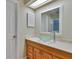 Bathroom with wood vanity, glass bowl sink, skylight and a large mirror at 748 Sagewood Dr, Lakeland, FL 33813