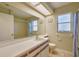 Bathroom with large mirror, bright lighting, tiled floors, and shower/tub combo at 748 Sagewood Dr, Lakeland, FL 33813